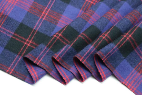 a close up of a purple and black plaid fabric