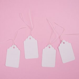 white apple earpods on pink surface
